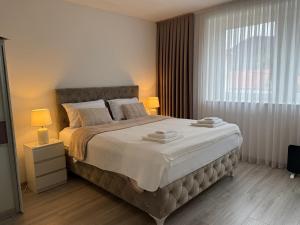 a bedroom with a large bed and a window at Bella stan na dan in Široki Brijeg +67 photos