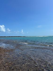 a rocky beach with the ocean in the background at Pousada Raios do Sol in Amontada +13 photos
