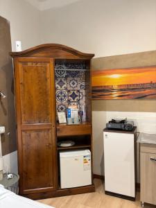 a kitchen with a cabinet and a refrigerator at Il Viale in Imola +2 photos