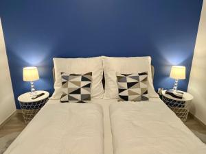a bedroom with a bed with two lamps on both sides at Interno Casa in Sopron