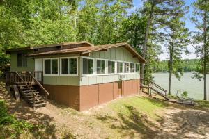 a tiny house on the shore of a lake at What A View - Zero Steps To The Dock! Yearround Water in Crane Hill
