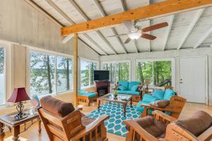 a living room with furniture and a ceiling fan at What A View - Zero Steps To The Dock! Yearround Water in Crane Hill