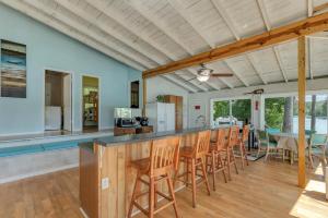 a kitchen and dining room with a bar and chairs at What A View - Zero Steps To The Dock! Yearround Water in Crane Hill