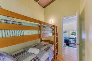 a bedroom with two bunk beds and a door at What A View - Zero Steps To The Dock! Yearround Water in Crane Hill +24 photos