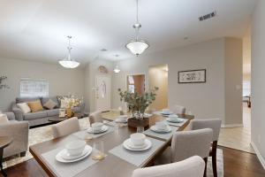 a dining room and living room with a table and chairs at Games, Backyard & Patio: Spacious Home in Frisco in Frisco