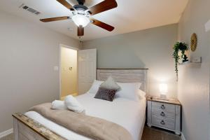 a bedroom with a bed with a ceiling fan at Games, Backyard & Patio: Spacious Home in Frisco in Frisco