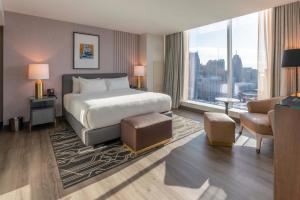a hotel room with a bed and a large window at Hollywood Casino at Greektown in Detroit