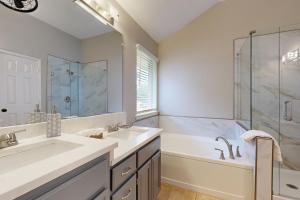 a bathroom with two sinks and a tub and a shower at Games, Backyard & Patio: Spacious Home in Frisco in Frisco +16 photos