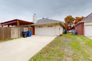a house with a garage and a fence at Games, Backyard & Patio: Spacious Home in Frisco in Frisco