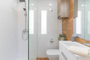 a bathroom with a shower and a toilet and a sink at Villa Perdices in Fuengirola