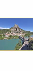 a view of a mountain with a road and water at Chez Luna in Sisteron