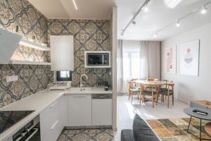 a kitchen and dining room with a table and chairs at Estia Luxury Apartment in Ierapetra
