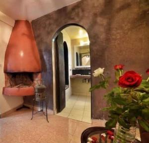 a room with a fireplace and a bathroom with a sink at Hostel & Riad in Essaouira