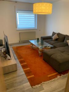 a living room with a couch and a coffee table at Wohnung zur Langzeitmiete geeignet in Bad Kreuznach +3 photos