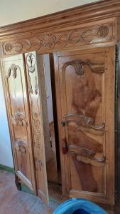 a wooden cabinet with a door in a room at OAK Familly in Saint-Racho