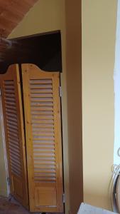 a wooden door in the corner of a room at OAK Familly in Saint-Racho