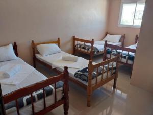 a group of four bunk beds in a room at Hotel e Restaurante Rota do Pampa in Estância Teixeira