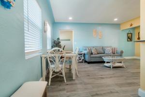 a living room with a couch and a table at Gorgeous Beach Condo in St. Petersburg +26 photos