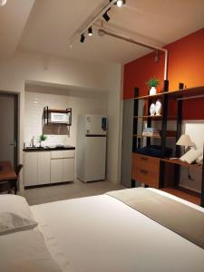 a bedroom with a white bed and a refrigerator at CoVivere - RJ in Rio de Janeiro +41 photos