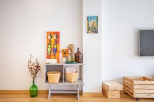a living room with a table with a tv at Alma de San Bernardo in Seville