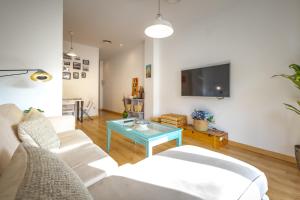 a living room with a couch and a table at Alma de San Bernardo in Seville