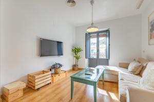 a living room with a couch and a table at Alma de San Bernardo in Seville