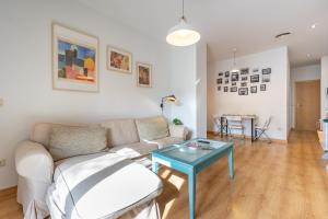 a living room with a couch and a table at Alma de San Bernardo in Seville +40 photos