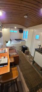 a room with two beds and a table and a kitchen at North Muasdale Farm - Byre View in Muasdale