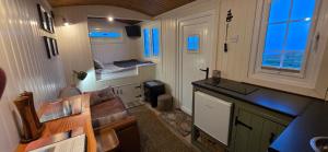 a tiny house with a kitchen and a living room at North Muasdale Farm - Byre View in Muasdale