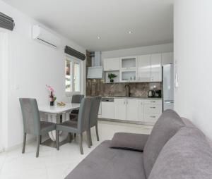 a kitchen and dining room with a couch and a table at Apartment Adriatic panorama view in Omiš