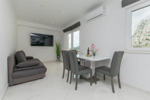 a dining room with a table and chairs at Apartment Adriatic panorama view in Omiš