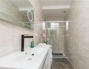 a white bathroom with a sink and a shower at Apartment Adriatic panorama view in Omiš +28 photos