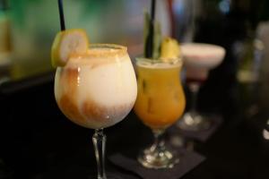 three cocktails sitting on a bar with at Stanhill Court Hotel, a member of Radisson Individuals in Horley +114 photos