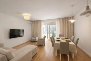 a living room with a table and chairs and a couch at Libertina Rafailovici in Rafailovici