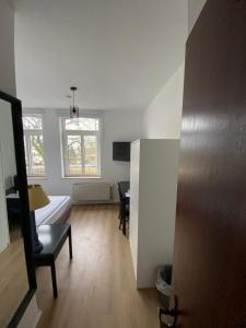 a living room with a couch and a table at Tanne Grand Palace in Alleringersleben +2 photos