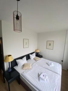 a white bed with two white towels on it at Tanne Grand Palace in Alleringersleben