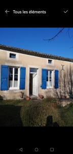 a house with blue shutters on the side of it at Blue Banane in Monflanquin +3 photos