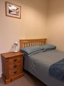 a bedroom with two beds and a table with a lamp at Apartment 2 at 2 Bell Street in Talgarth