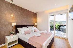 a bedroom with a bed with two towels on it at Villa dal' Mares in Vinišće +61 photos