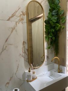 a bathroom with a mirror and a sink at Hostel Amor por SP - BRÁS in São Paulo +37 photos