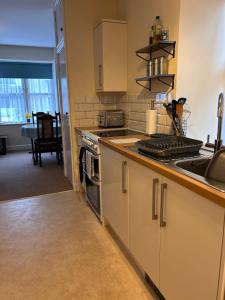a kitchen with a sink and a stove top oven at Apartment 2 at 2 Bell Street in Talgarth