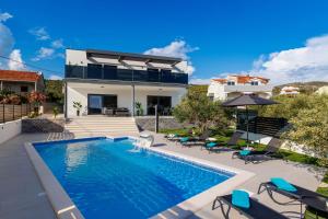 a swimming pool in the backyard of a house at Villa dal' Mares in Vinišće