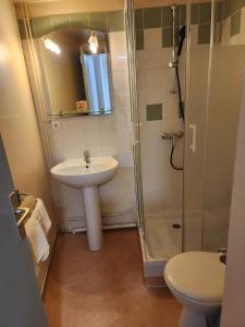 a bathroom with a sink and a shower at La Bona Taula By A&J in Rochefort-Montagne
