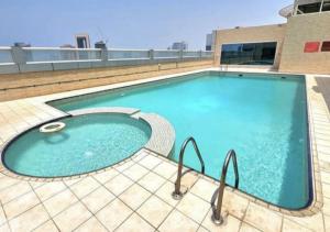 a large swimming pool on top of a building at Panoramic Sea apartment & Skyline View Private Room in Sharjah