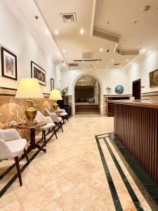 a lobby with chairs and a table and a bar at Christmas Hotel - Jerusalem in Jerusalem