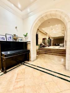 a large room with a piano in the middle of it at Christmas Hotel - Jerusalem in Jerusalem
