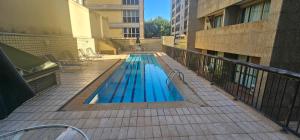 a swimming pool on a balcony of a building at Charme e Conforto na Savassi in Belo Horizonte