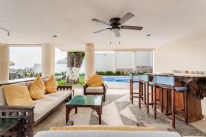 a living room with a couch and a ceiling fan at Private villa, 6 bedrooms, 2 pools with views in Acapulco