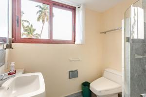 a bathroom with a sink and a toilet and a window at Private villa, 6 bedrooms, 2 pools with views in Acapulco +93 photos