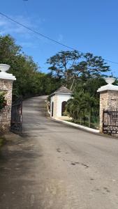 an empty street with a gate and a building at Wrightian in Kupuis +6 photos